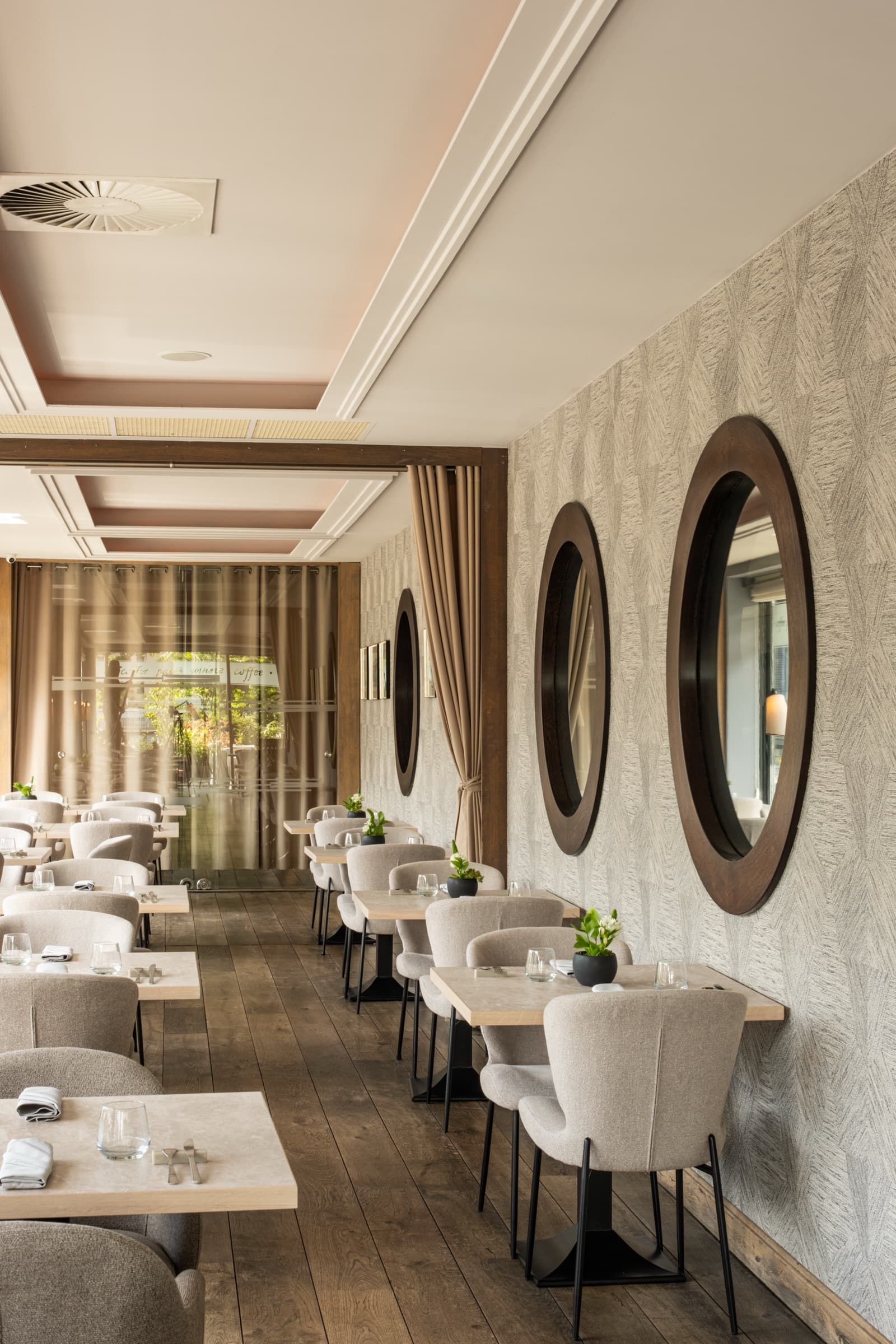 Przystań & Marina — elegant restaurant interior with round mirrors and neutral upholstery, Wrocław
